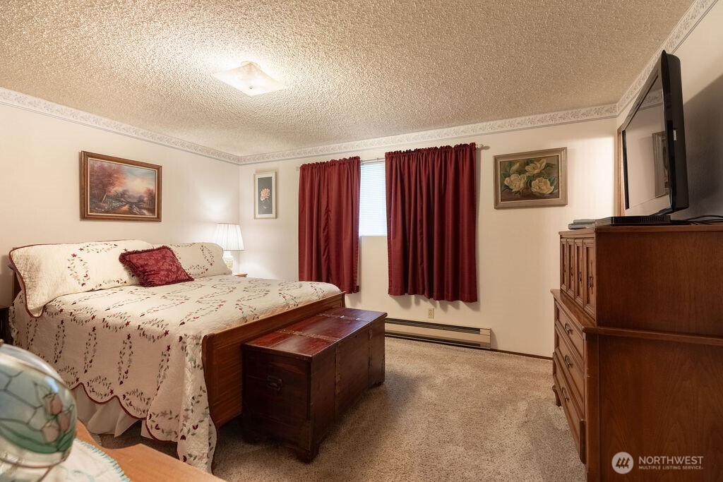 371 Flora Place Forks, WA 98331 - Photo 18 of 40 a bedroom with a bed and a flat screen tv