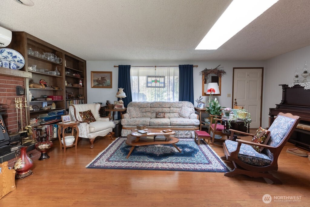 371 Flora Place Forks, WA 98331 - Photo 2 of 40 a living room with furniture and a fireplace