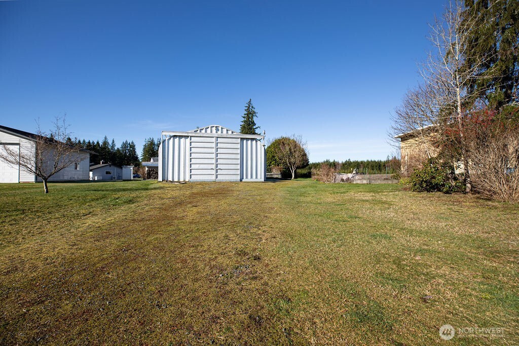 371 Flora Place Forks, WA 98331 - Photo 30 of 40 a view of a big yard with large trees