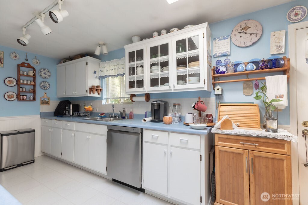371 Flora Place Forks, WA 98331 - Photo 6 of 40 a kitchen with stainless steel appliances granite countertop a sink stove and cabinets