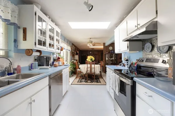 a kitchen with stainless steel appliances granite countertop a sink and cabinets