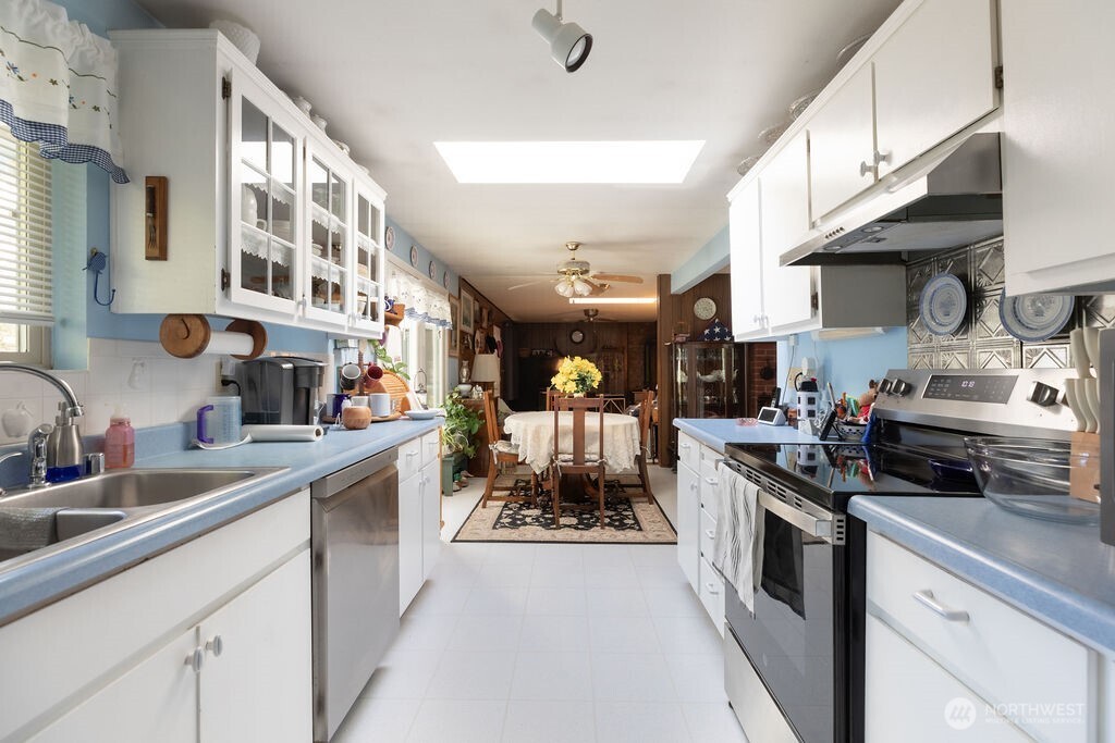 371 Flora Place Forks, WA 98331 - Photo 9 of 40 a kitchen with stainless steel appliances granite countertop a sink and cabinets