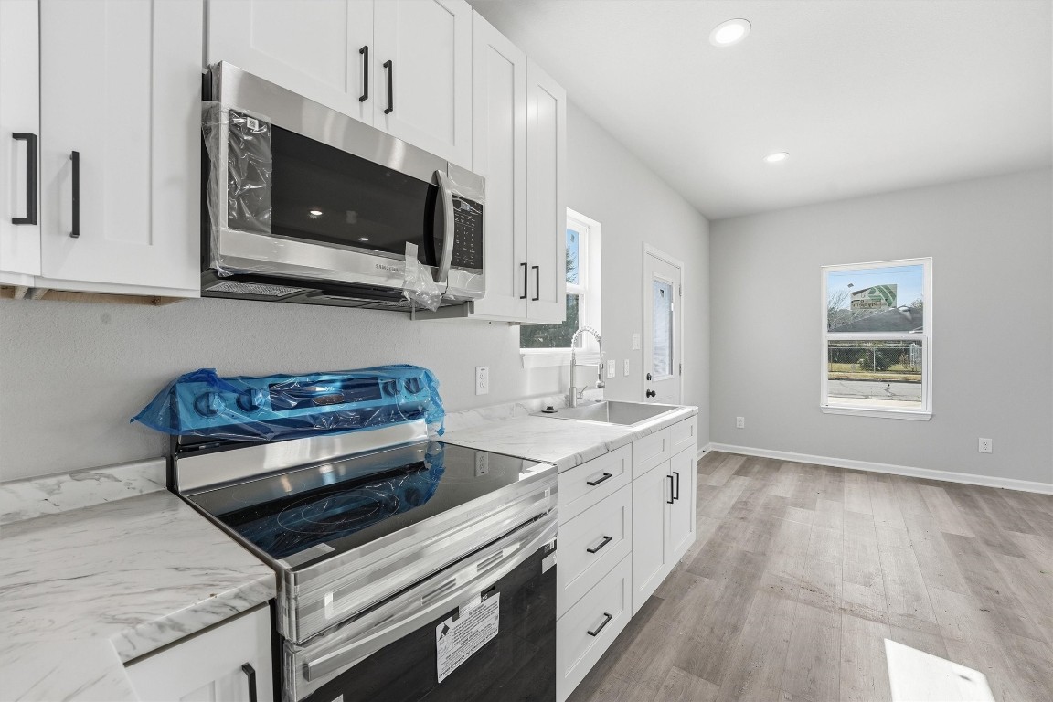 2250 Cable Avenue Beaumont, TX 77703 - Photo 11 of 21 a kitchen with stainless steel appliances kitchen island granite countertop a sink and a stove