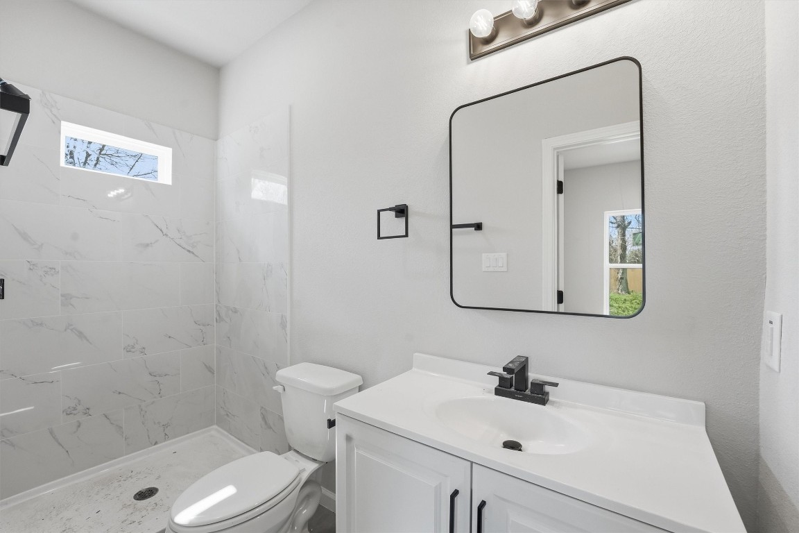 2250 Cable Avenue Beaumont, TX 77703 - Photo 19 of 21 a bathroom with a sink a toilet and shower