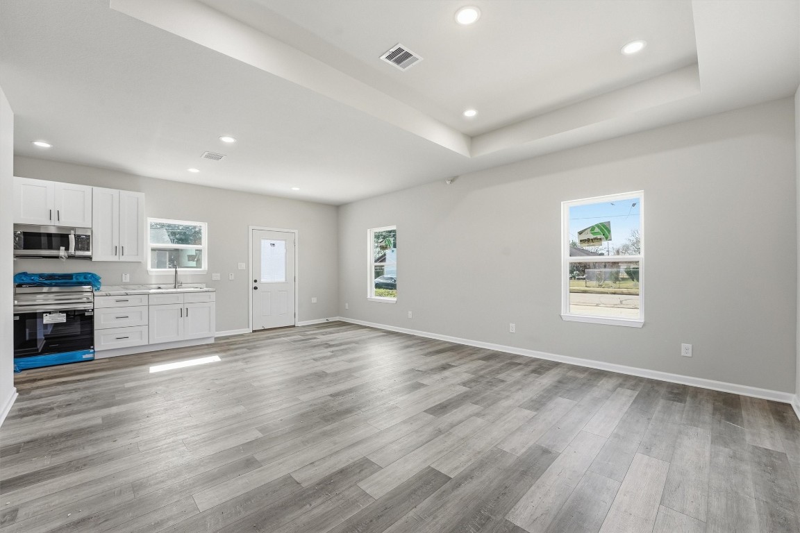 2250 Cable Avenue Beaumont, TX 77703 - Photo 3 of 21 a view of a kitchen with wooden floor and electronic appliances