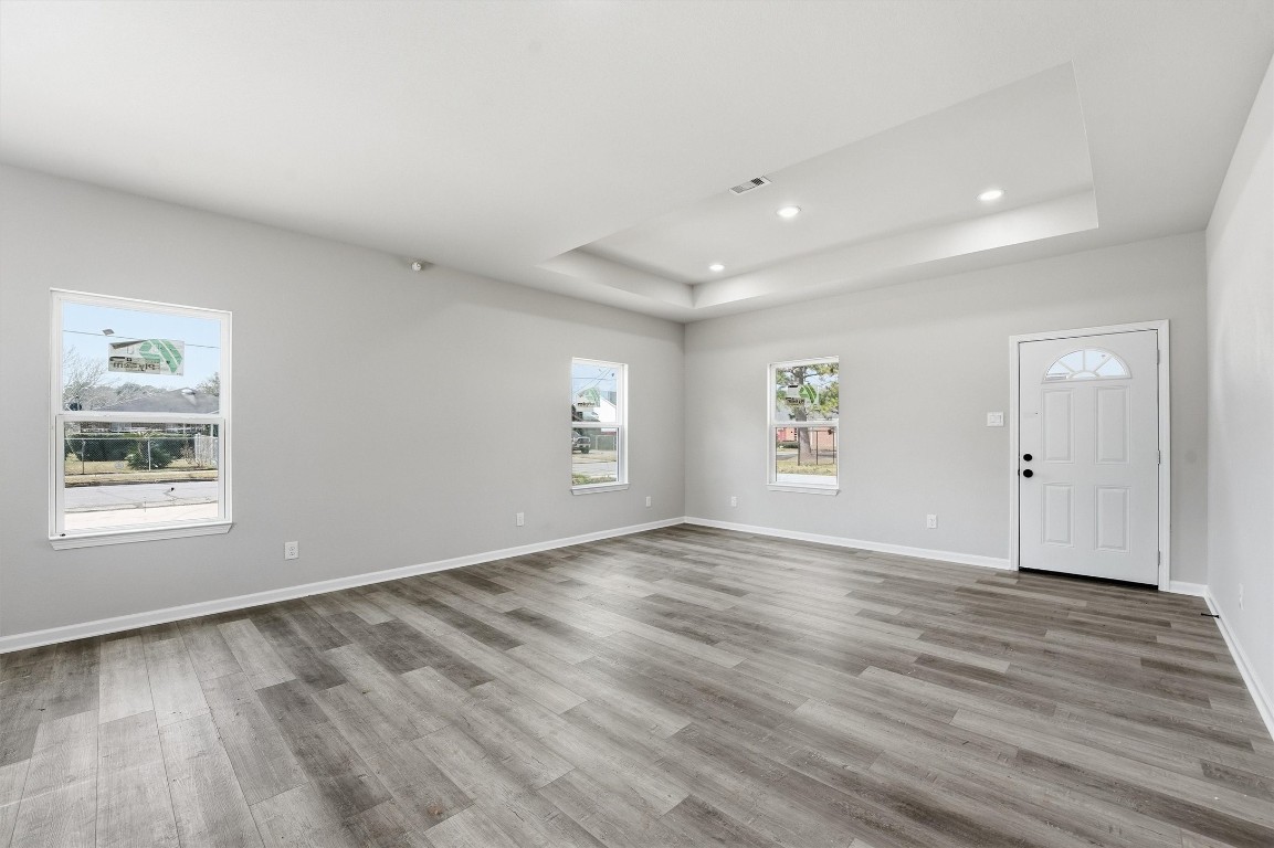 2250 Cable Avenue Beaumont, TX 77703 - Photo 4 of 21 an empty room with wooden floor and windows