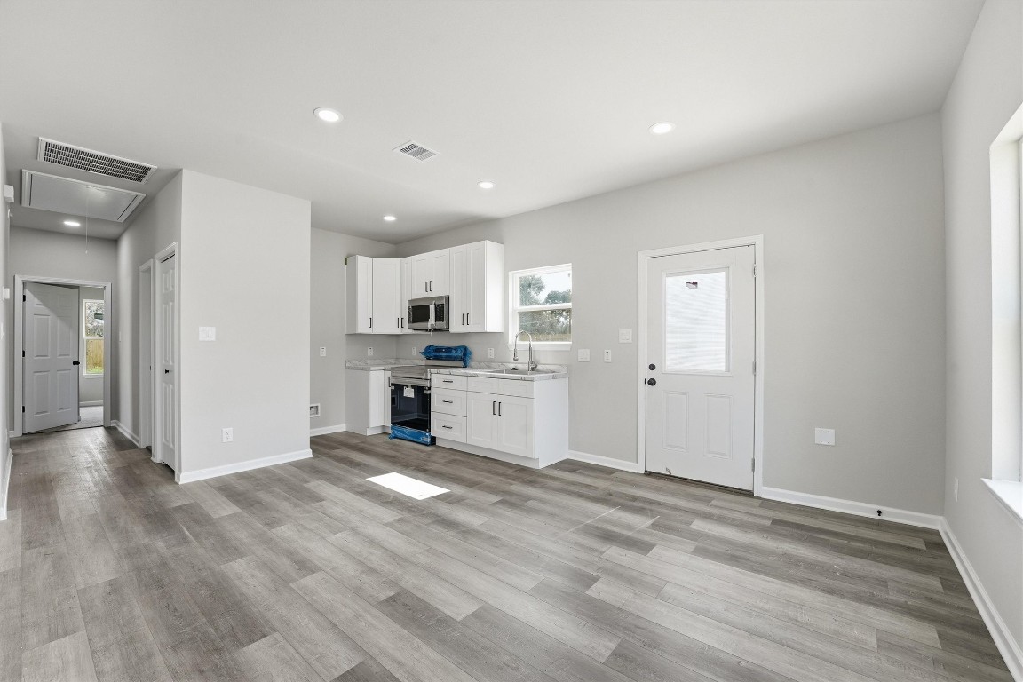 2250 Cable Avenue Beaumont, TX 77703 - Photo 7 of 21 a view of a kitchen with wooden floor and windows