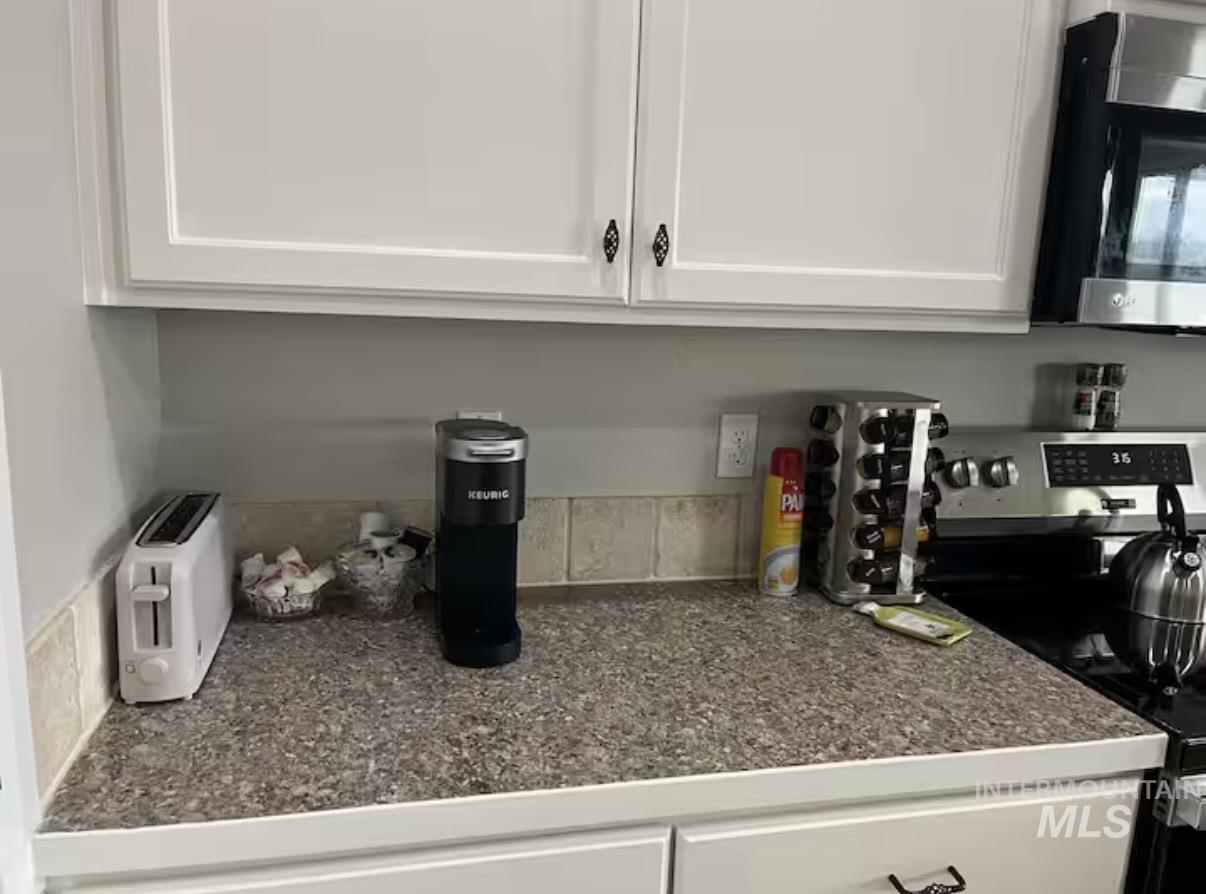 723 Stallion Springs Way Middleton, ID 83644 - Photo 10 of 50 Detailed view of stainless steel appliances and white cabinets