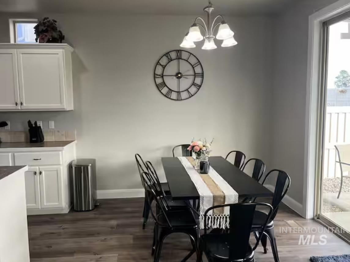 723 Stallion Springs Way Middleton, ID 83644 - Photo 13 of 50 Dining space with dark wood-type flooring and a chandelier