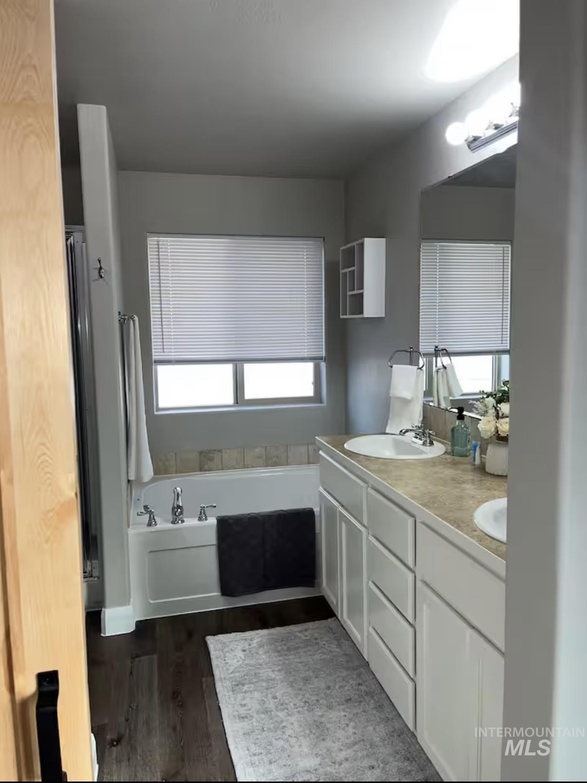 723 Stallion Springs Way Middleton, ID 83644 - Photo 23 of 50 Full bathroom featuring double vanity, a bath, and dark wood-type flooring