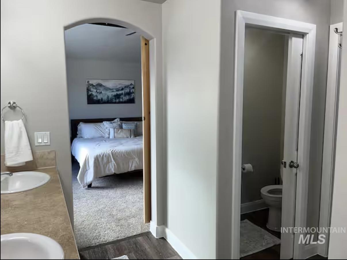 723 Stallion Springs Way Middleton, ID 83644 - Photo 25 of 50 Full bathroom featuring double vanity, wood finished floors, and ensuite bath