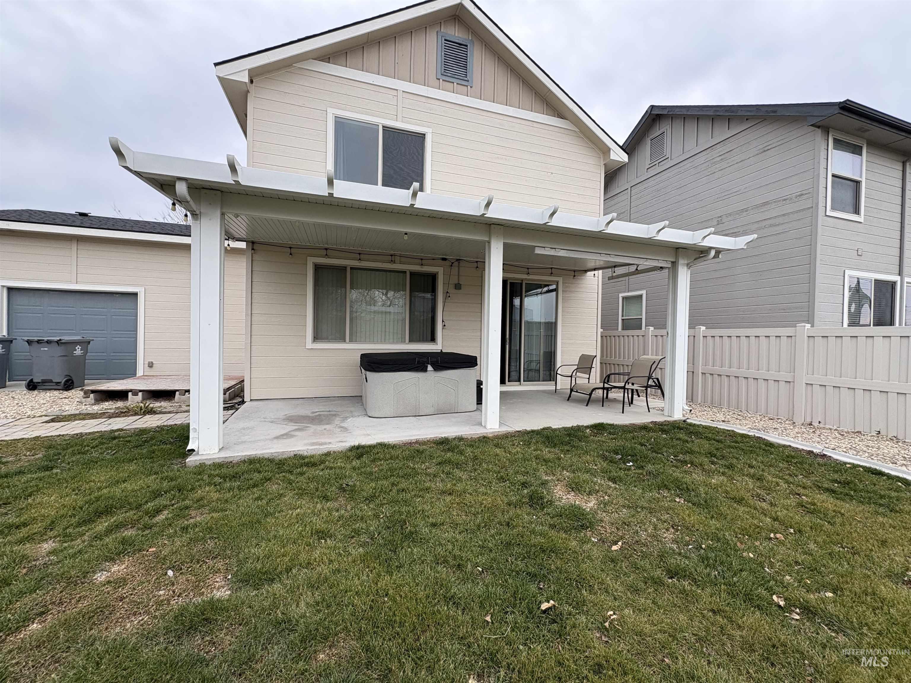 723 Stallion Springs Way Middleton, ID 83644 - Photo 42 of 50 Back of property featuring a patio, board and batten siding, and a hot tub