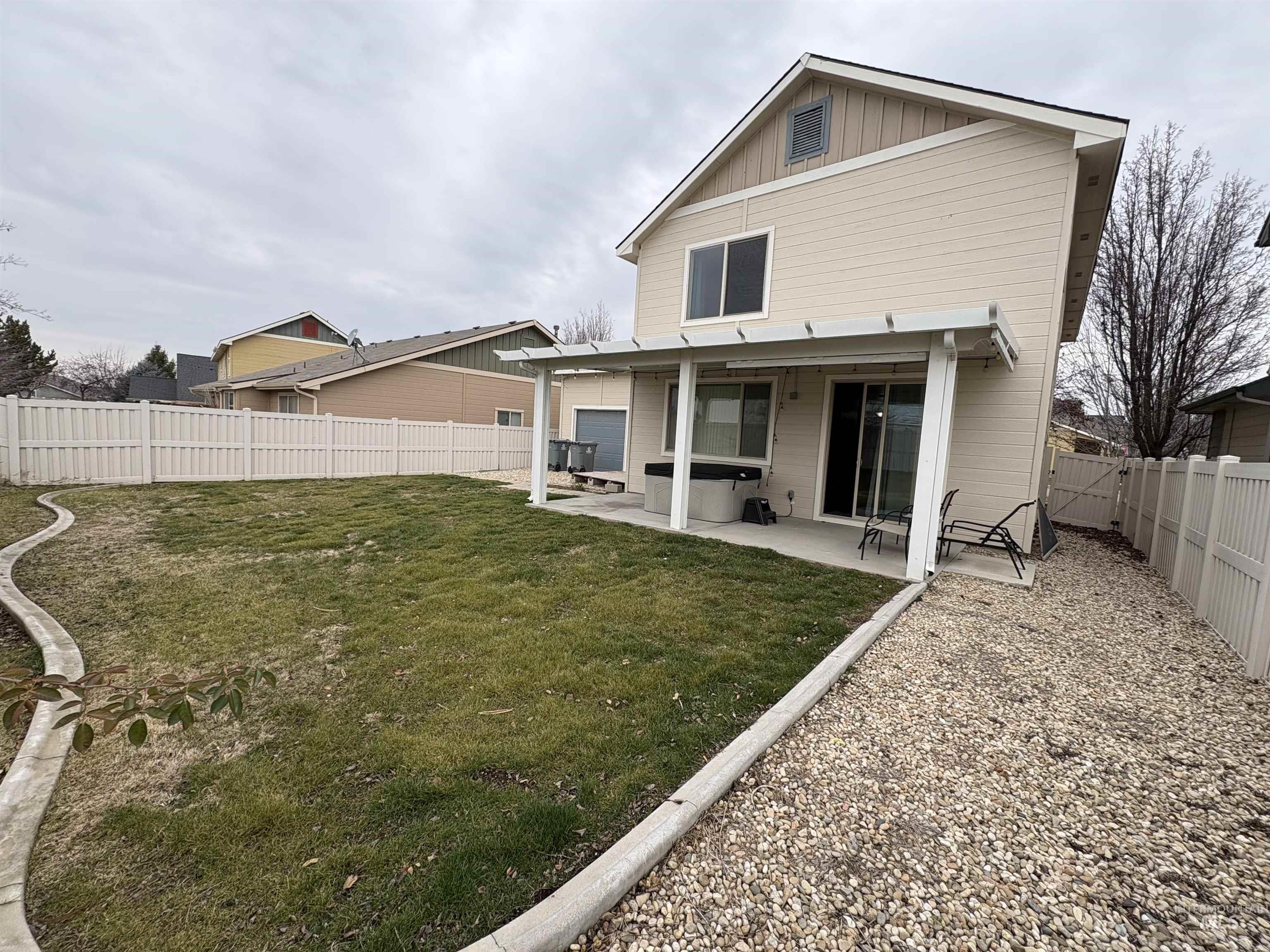 723 Stallion Springs Way Middleton, ID 83644 - Photo 44 of 50 Back of house featuring a patio, a fenced backyard, and board and batten siding