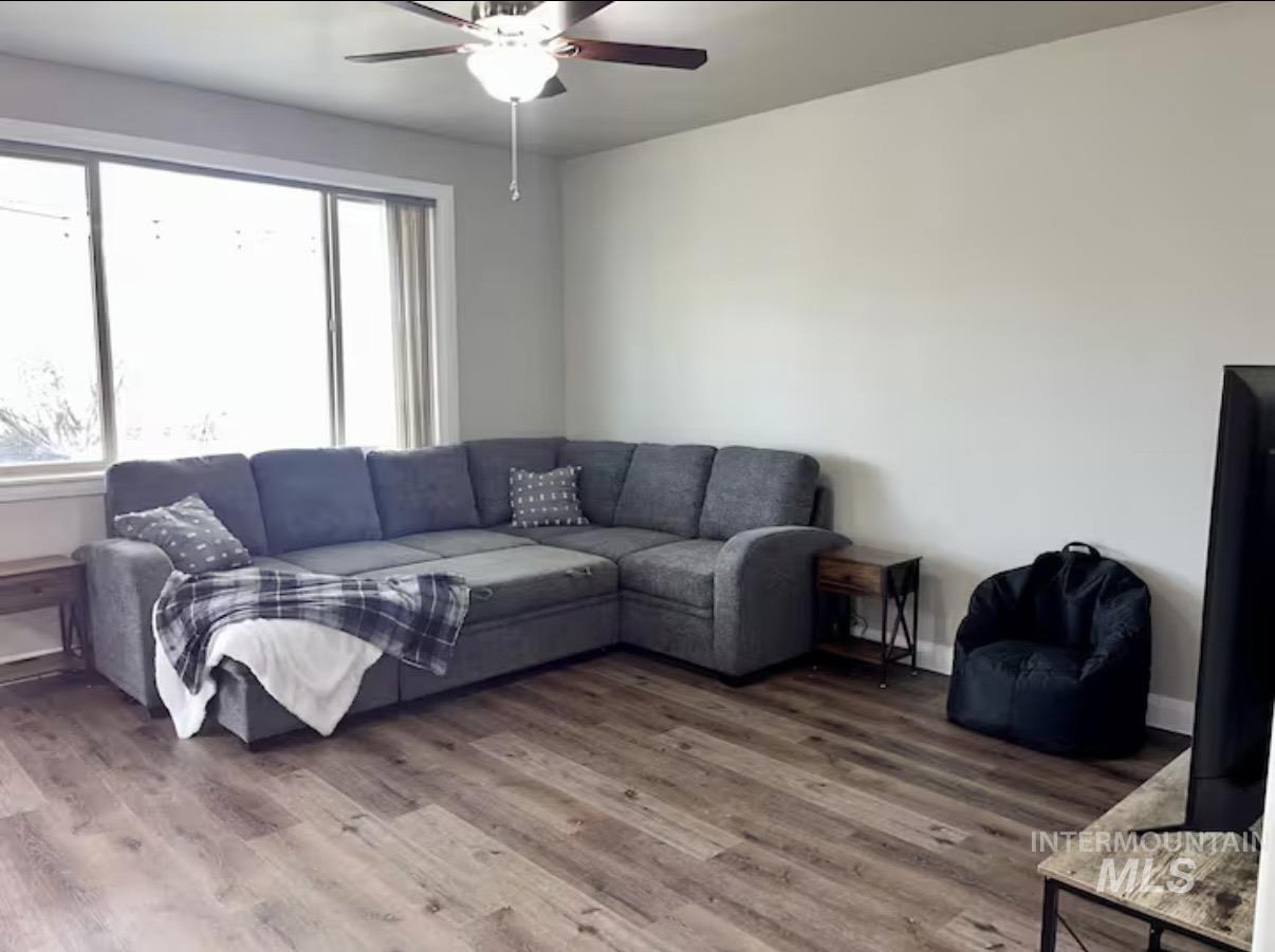 723 Stallion Springs Way Middleton, ID 83644 - Photo 7 of 50 Living room featuring wood finished floors and a ceiling fan