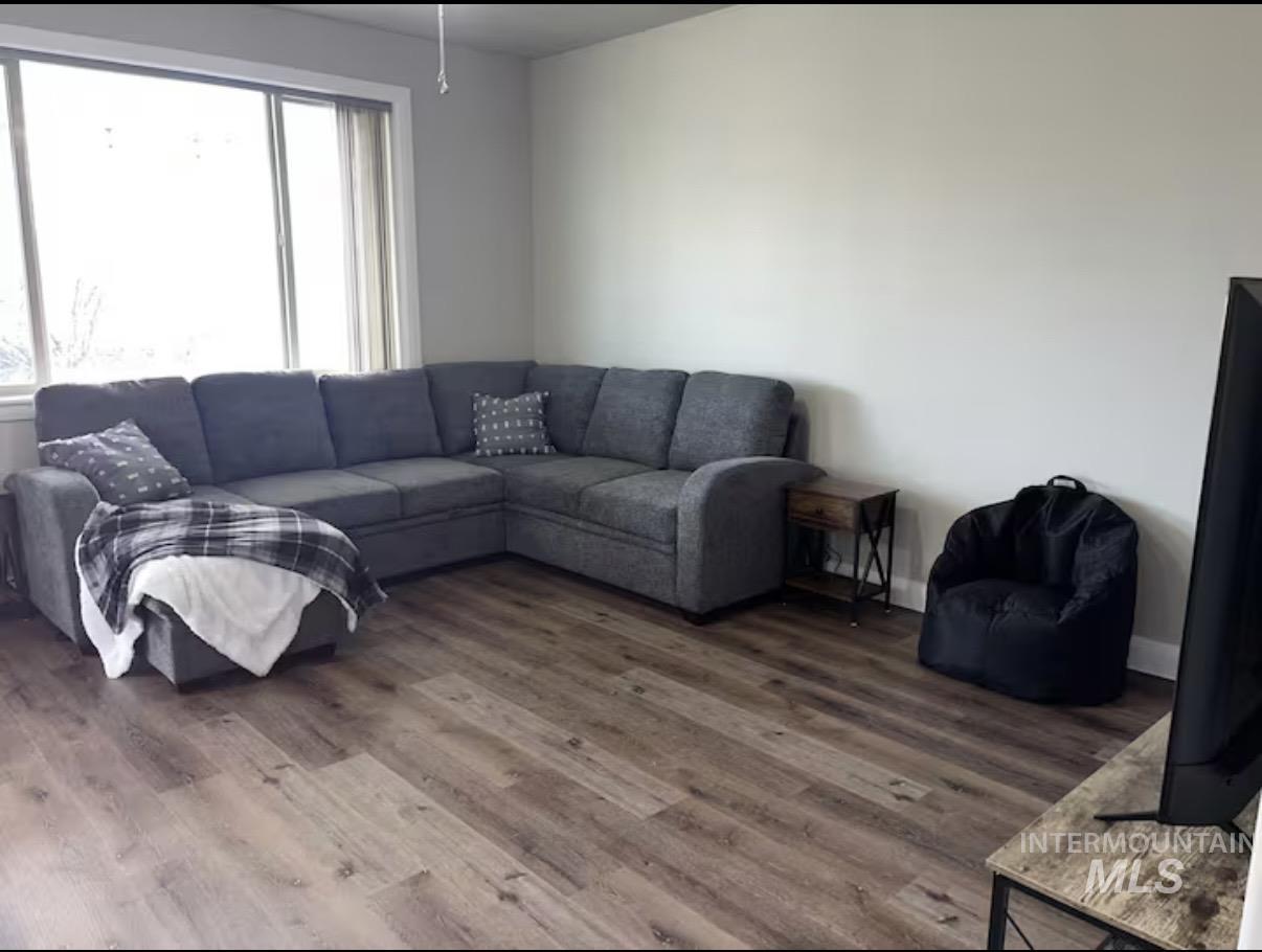 723 Stallion Springs Way Middleton, ID 83644 - Photo 9 of 50 Living area featuring wood finished floors and baseboards