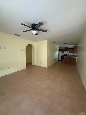 a view of a livingroom with furniture and a ceiling fan