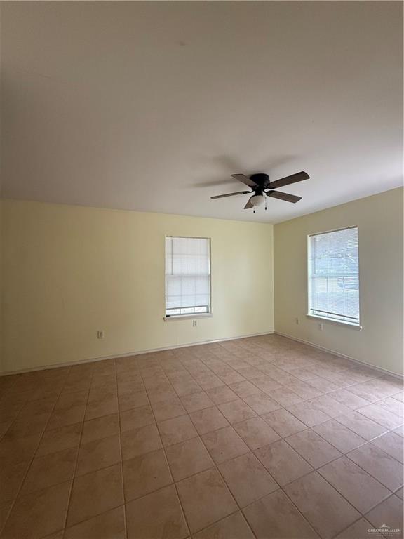 1213 Mineral Rights Lane, Unit 4 Edinburg, TX 78541 - Photo 9 of 10 an empty room with windows and fan