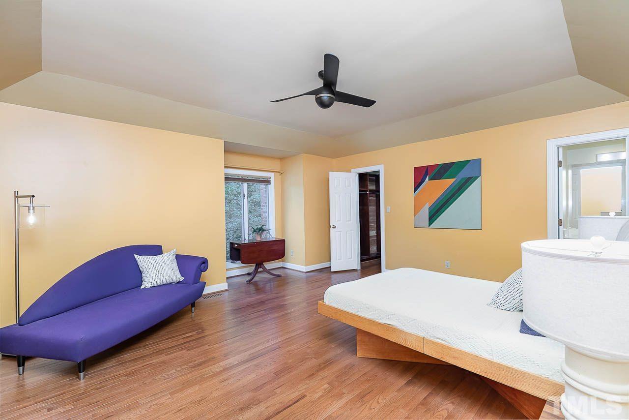 212 Carpathian Way Raleigh, NC 27615 - Photo 13 of 24 a bedroom with a bed and couch