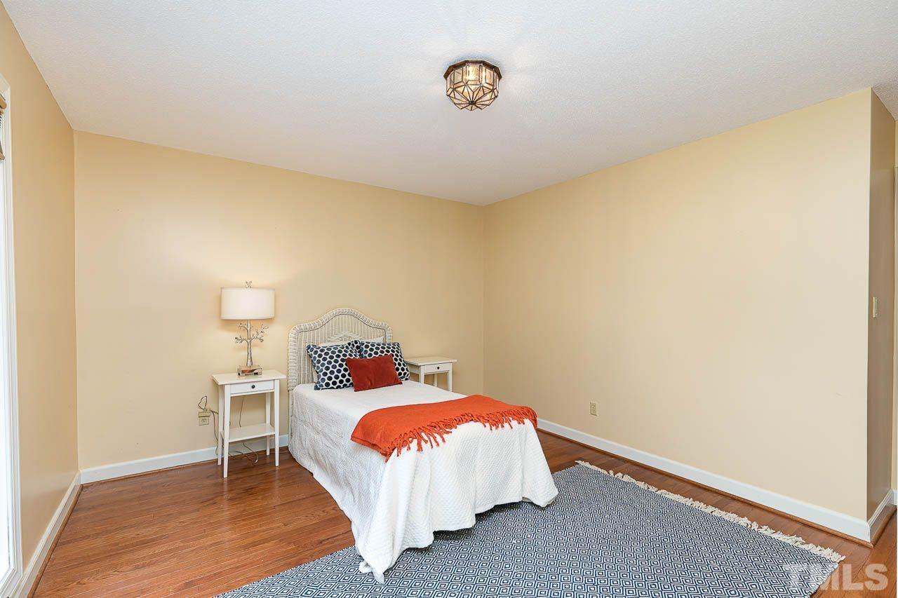 212 Carpathian Way Raleigh, NC 27615 - Photo 15 of 24 a bedroom with a bed and a table