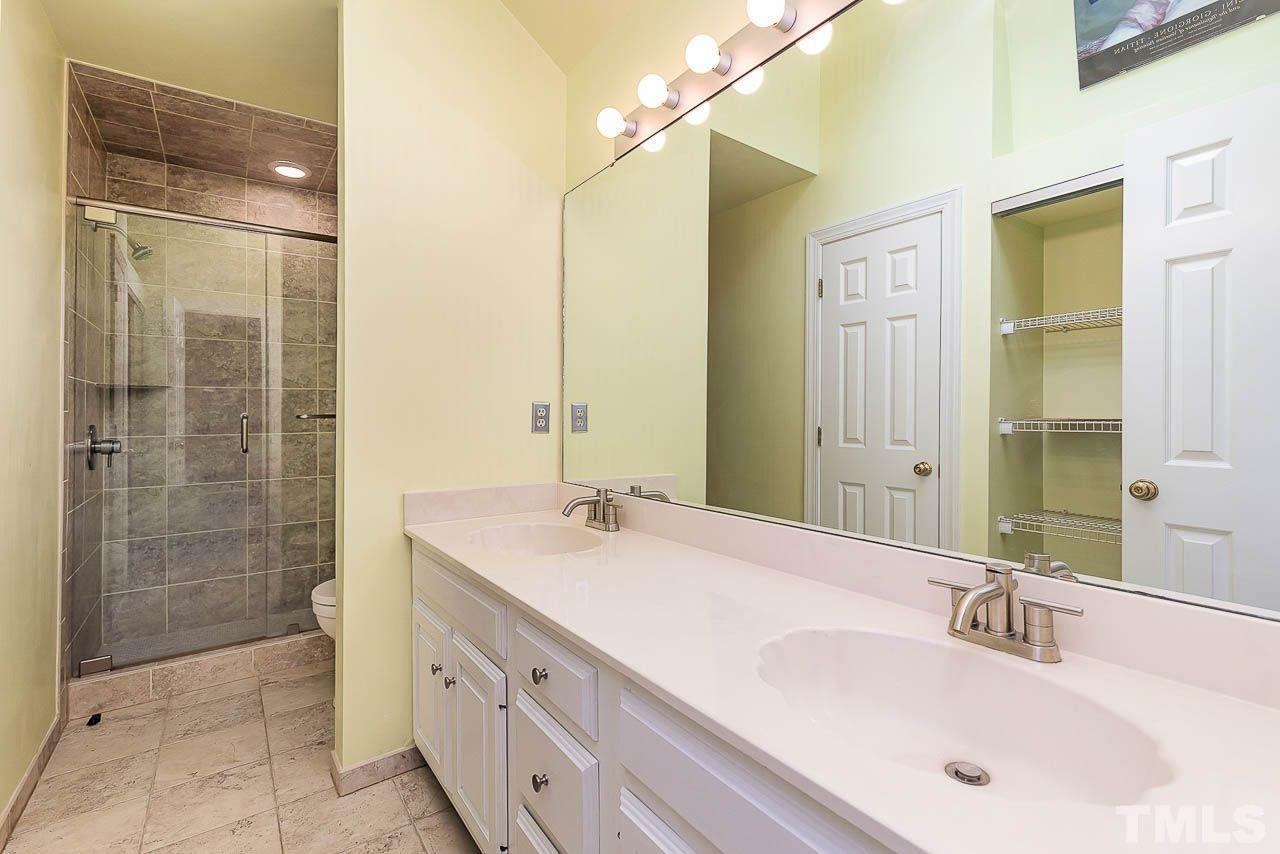 212 Carpathian Way Raleigh, NC 27615 - Photo 17 of 24 a bathroom with a double vanity sink mirror and shower