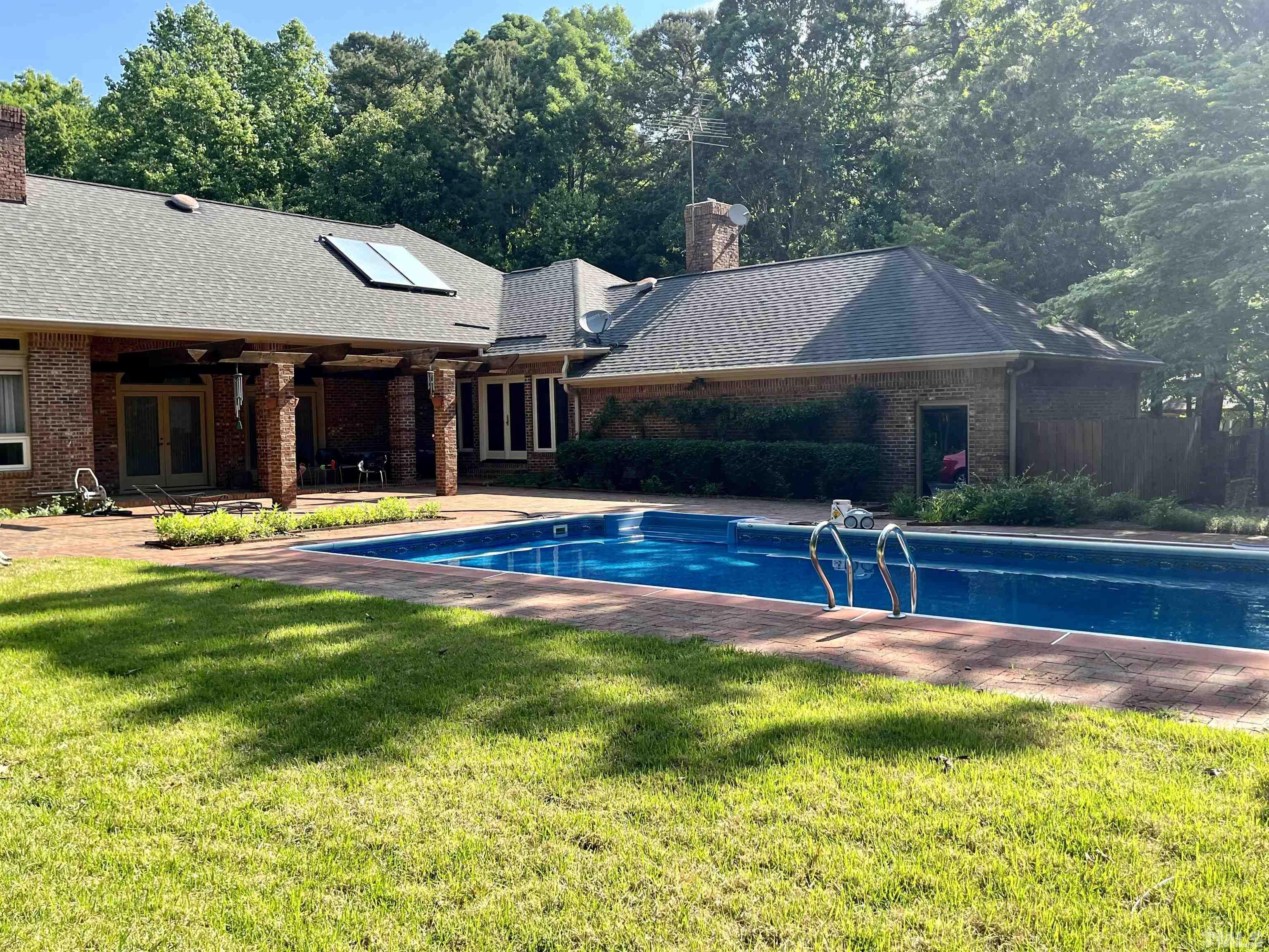 212 Carpathian Way Raleigh, NC 27615 - Photo 3 of 24 a view of a house with swimming pool and a yard