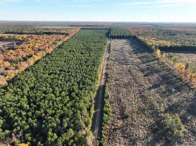 an aerial view of a houses with a lake
