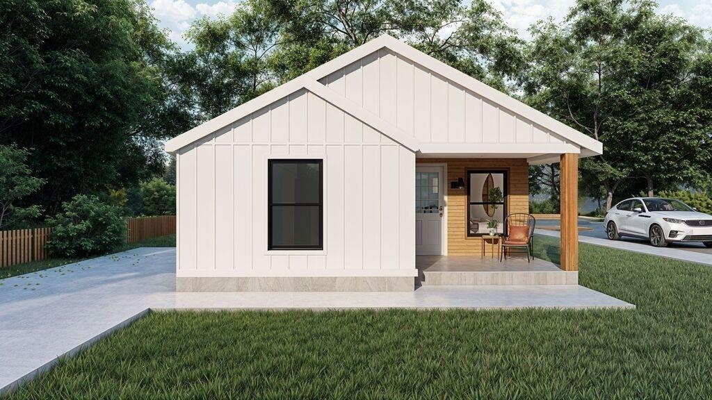 742 King Road Memphis, TN 38109 - Photo 1 of 3 a view of a white house next to a yard with large trees