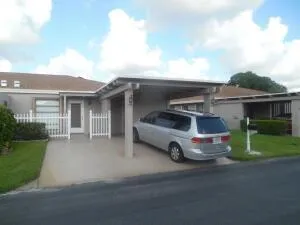 a car parked in front of white house