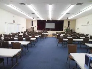 a living room with lots of furniture and view of kitchen