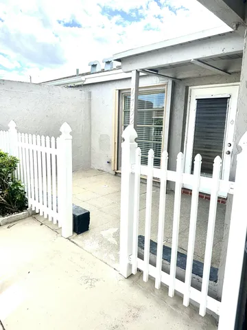 a view of a balcony with wooden floor and fence