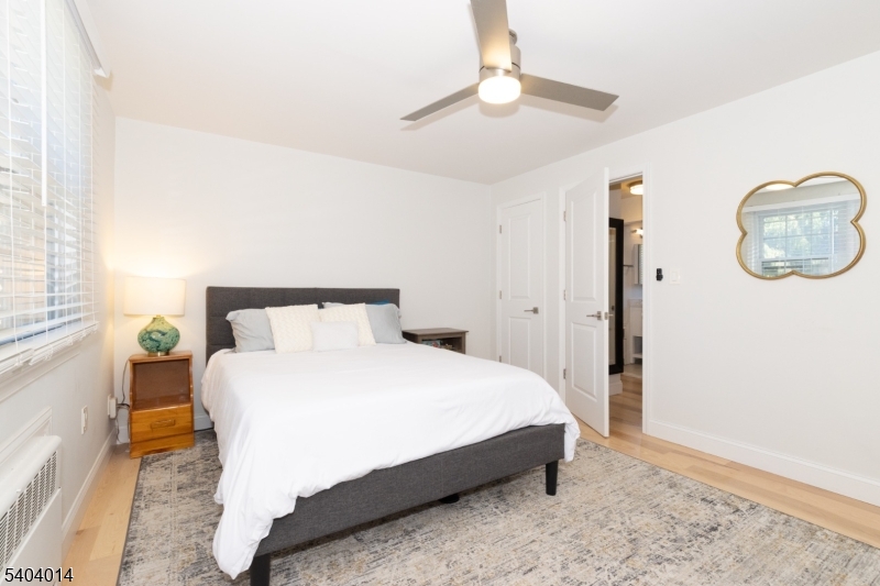 445 Morris Avenue Springfield, NJ 07081 - Photo 13 of 15 a bedroom with a bed and a chandelier