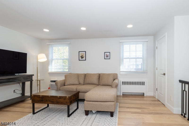445 Morris Avenue Springfield, NJ 07081 - Photo 5 of 15 a living room with furniture and a flat screen tv