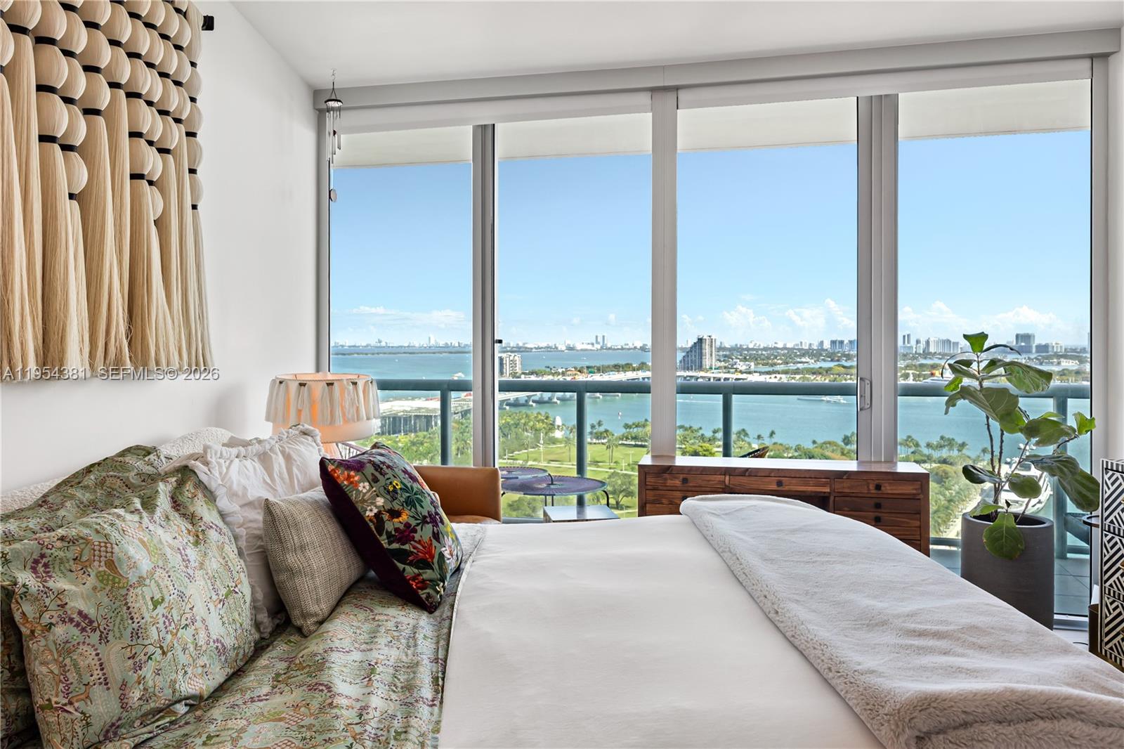 888 Biscayne Boulevard, Unit 2009 Miami, FL 33132 - Photo 1 of 21 a bedroom with a bed and large windows