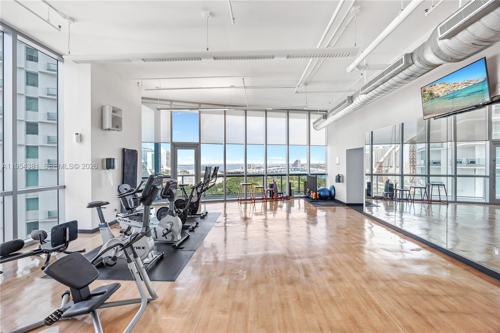888 Biscayne Boulevard, Unit 2009 Miami, FL 33132 - Photo 16 of 21 a view of a work space with furniture and floor to ceiling window