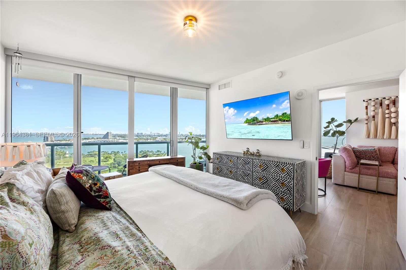 888 Biscayne Boulevard, Unit 2009 Miami, FL 33132 - Photo 2 of 21 a bedroom with a large bed and a large window