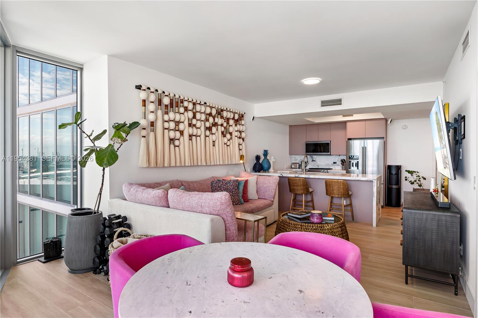 888 Biscayne Boulevard, Unit 2009 Miami, FL 33132 - Photo 3 of 21 a living room with furniture fireplace and a window