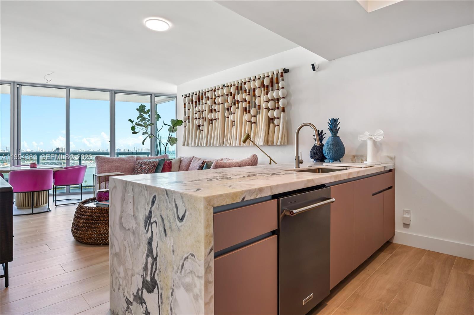 888 Biscayne Boulevard, Unit 2009 Miami, FL 33132 - Photo 6 of 21 a kitchen with a sink stove and cabinets