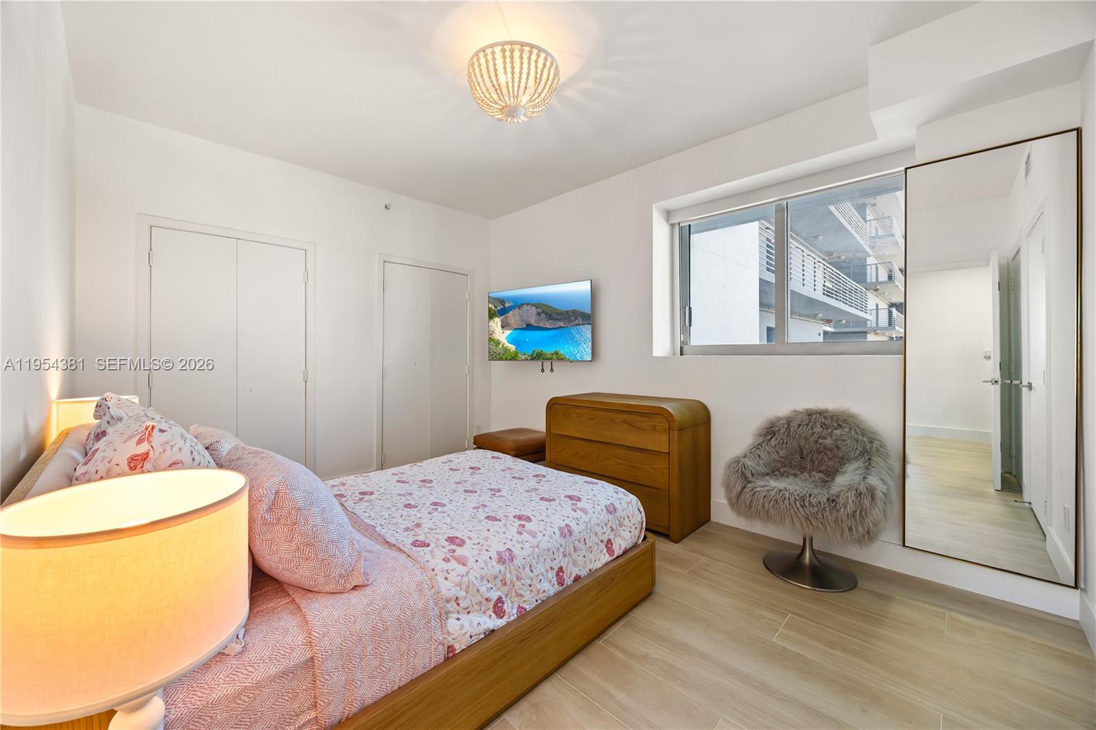 888 Biscayne Boulevard, Unit 2009 Miami, FL 33132 - Photo 7 of 21 a bedroom with a bed and window