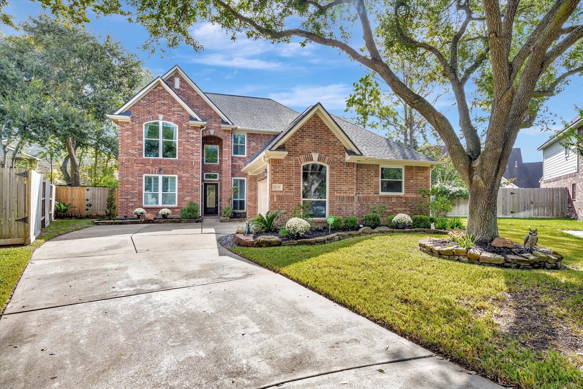 1639 Lakeside Enclave Drive Houston, TX 77077 - Photo 1 of 38 a view of a yard in front of a house with a large tree