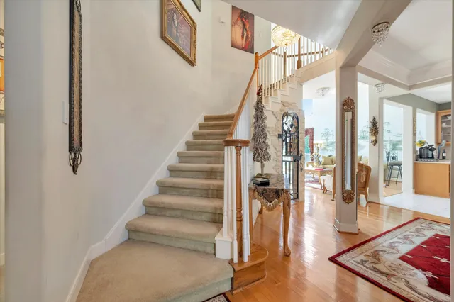 a view of entryway and hall with wooden floor