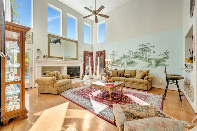 a living room with furniture fireplace and a table