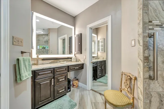a bathroom with a glass shower door and a glass door shower