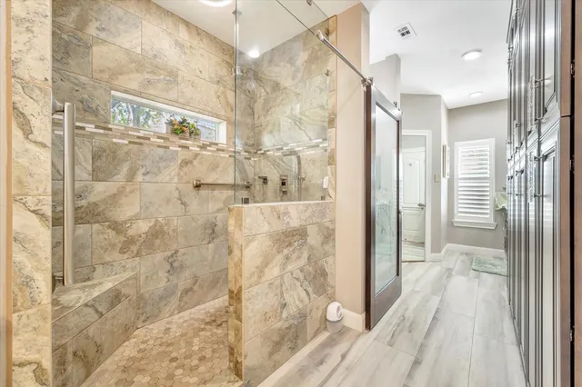 a bathroom with a granite countertop sink and a window