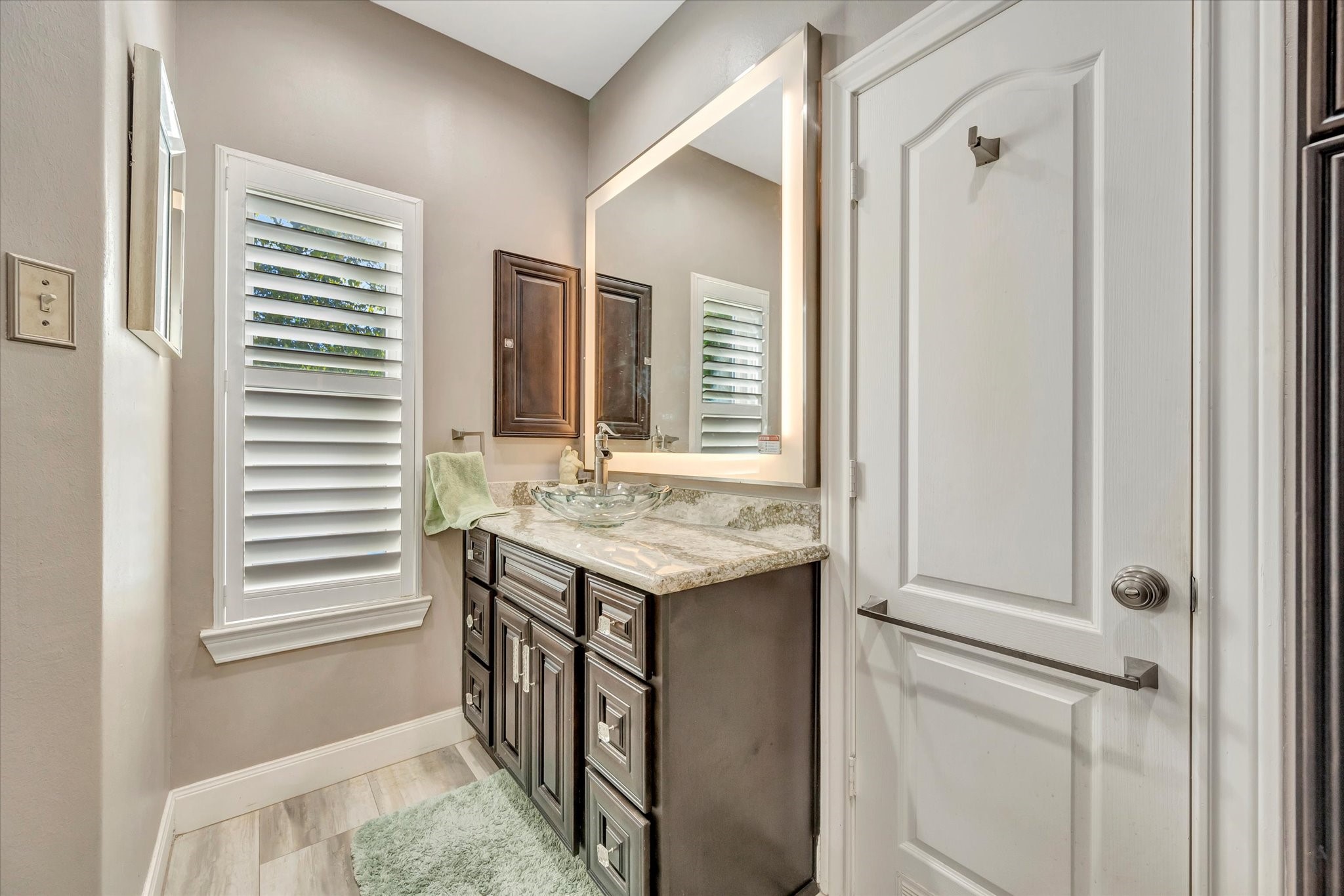 1639 Lakeside Enclave Drive Houston, TX 77077 - Photo 27 of 38 a bathroom with a granite countertop sink and a window