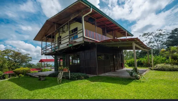 a view of a chair and table in backyard of the house