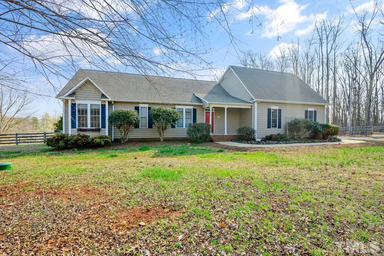 7001 New Sharon Church Road Rougemont, NC 27572 - Photo 2 of 52 a front view of a house with a garden