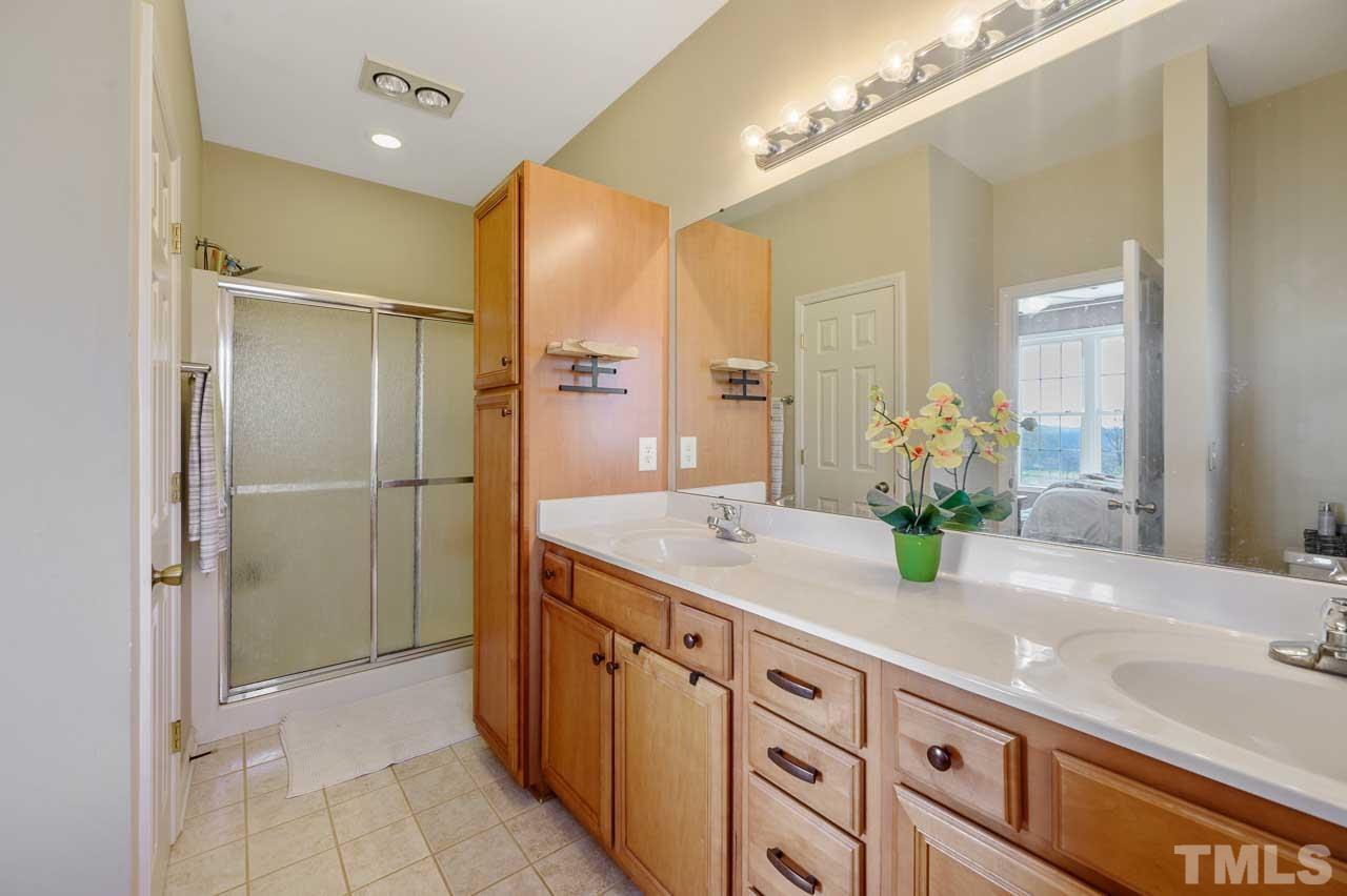 7001 New Sharon Church Road Rougemont, NC 27572 - Photo 21 of 52 a bathroom with a granite countertop sink and a mirror