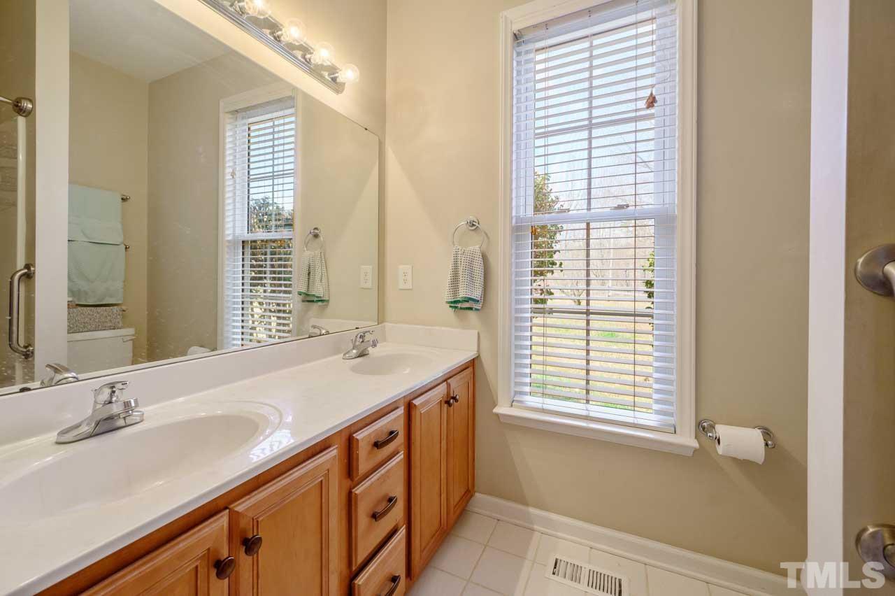 7001 New Sharon Church Road Rougemont, NC 27572 - Photo 24 of 52 a bathroom with a granite countertop sink and a window