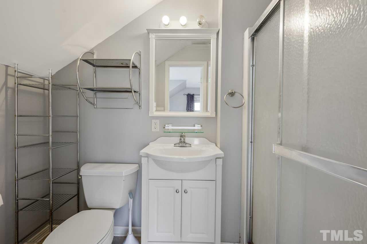 7001 New Sharon Church Road Rougemont, NC 27572 - Photo 31 of 52 a bathroom with a toilet sink and mirror