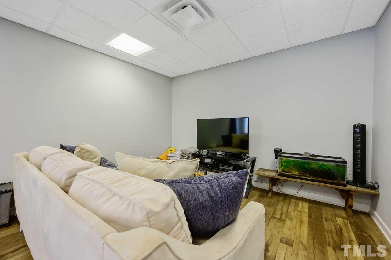7001 New Sharon Church Road Rougemont, NC 27572 - Photo 39 of 52 a living room with furniture and a flat screen tv